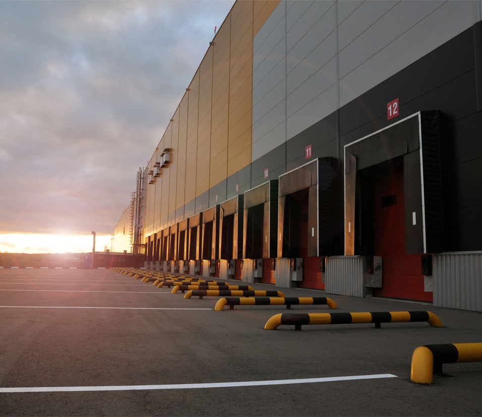 Warehouse logistics complex in the rays of the rising sun.